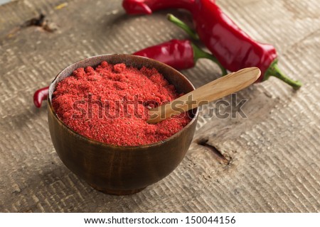 Dry chili pepper in wooden bowl  on dark table. Fresh chili peppers. Selective focus.