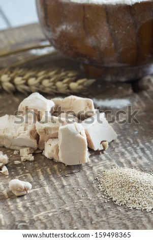Dry and fresh yeast on old wooden background. Rustic style. Selective focus. Natural/organic/bio/eco products.