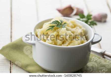 Fresh mashed potatoes in white bowl  on wooden background. Selective focus.