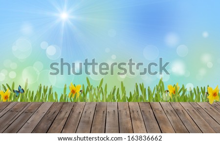 Abstract spring background for design. Grass with flowers and wooden floor. Easter/summer background. Meadow.