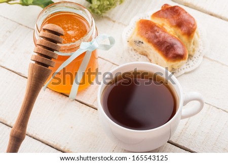 Cup of tea, honey, homemade pastry.  Selective focus.