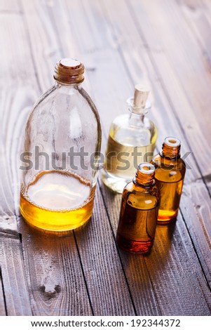 Bottles with aroma oil, medicines  on wooden background. Selective focus, vertical.