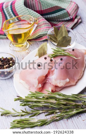 Fresh chicken meat  on white table with spices. Selective focus, vertical. Rustic style.