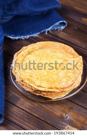 Appetizing pancakes on plate on table. Healthy breakfast. Selective focus, vertical.