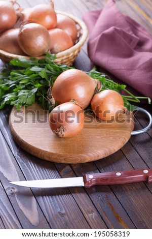 Fresh organic onion on wooden background. Selective focus, vertical.