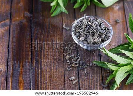 Dry herbal tea  on wooden background. Fresh mint. Selective focus, horizontal.