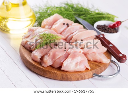 Fresh chicken meat on wooden board on table. Selective focus, horizontal.