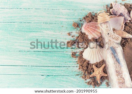 Marine items on sand  on wooden background. Sea objects on wooden planks. Selective focus.