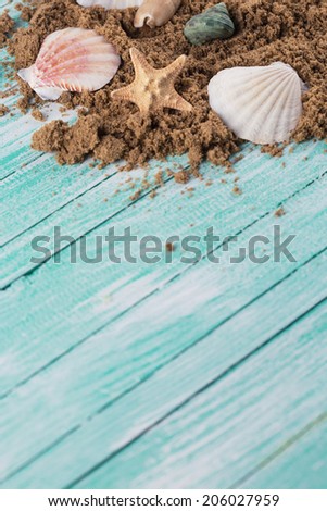 Marine items on sand  on wooden background. Sea objects on wooden planks. Selective focus.