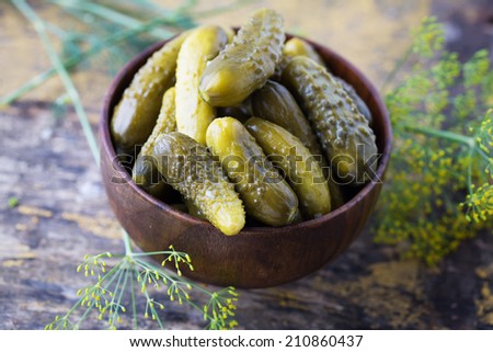 Pickled organic cucumbers in bowl on  wooden table. Selective focus. Natural/organic/bio/healthy products.