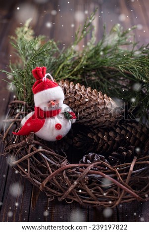 Decorative christmas composition - frosty, wreath and spruce  on wooden background. Selective focus.