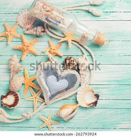 Marine items on turquoise wooden background. Sea objects on wooden planks. Selective focus. Place for text.