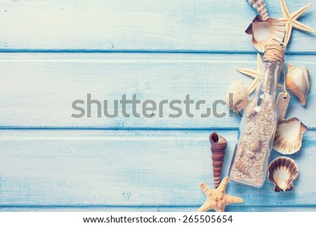 Marine items on blue painted wooden background. Sea objects on wooden planks. Toned image. Selective focus.