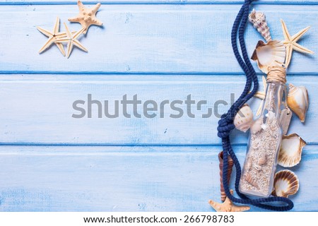 Marine items on blue painted wooden background. Place for text.  Selective focus.