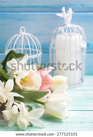 Postcard  with fresh pink  hyacinths in box and willow branches on turquoise painted  wooden planks against white wall. Selective focus.