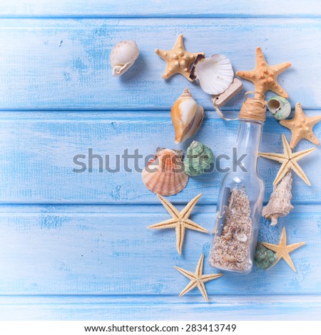 Different marine items on  blue painted wooden background. Sea objects on wooden planks. Selective focus. Place for text.  Square image.