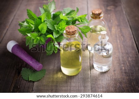 Essential aroma oil with mint on wooden background. Selective focus. Toned image.