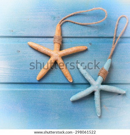 Marine items on blue wooden background. Sea objects on wooden planks. Selective focus. Place for text. Square image.