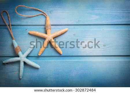 Marine items on blue wooden background. Sea objects on wooden planks. Selective focus. Place for text. Toned image.