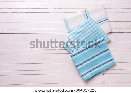 Colorful blue  kitchen towels  on white wooden background. Selective focus. Place for text.