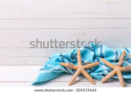 Marine items  and blue towel  on white wooden background.  Selective focus. Place for text.