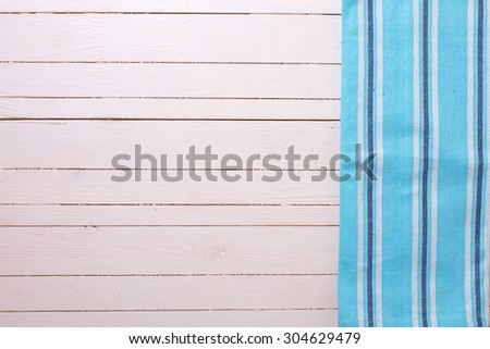 Blue kitchen towel  on white wooden background. Selective focus. Place for text.