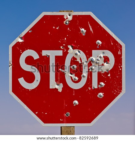 Stop Sign.  Close up of American Stop sign by the road.  Shot out with bullet holes, taken in Monument Valley