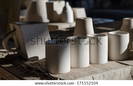 Handmade pottery on shelf in factory,still life
