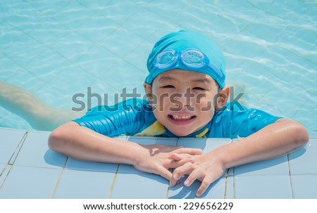 Happy Asian boy in swimming pool
