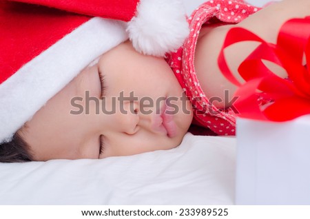 Sleeping baby girl Santa Claus