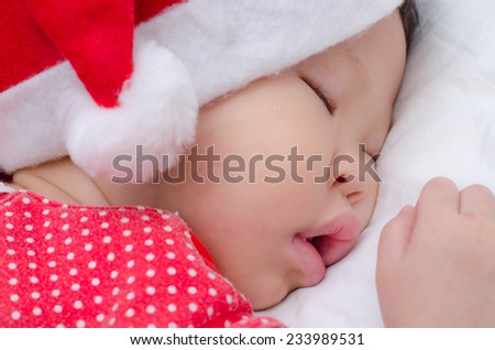 Sleeping baby girl Santa Claus