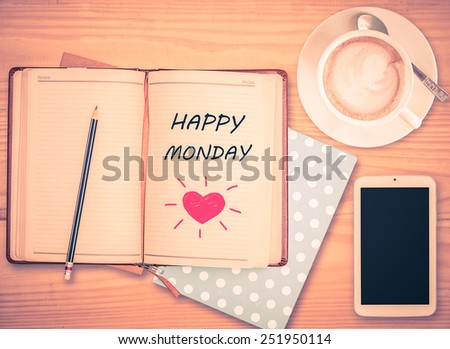 Happy Monday on notebook , pencil, smart phone and coffee cup with vintage filter