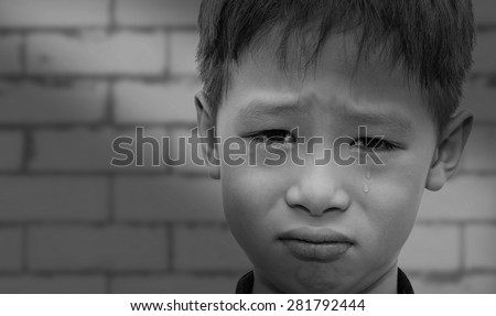 Close up of crying Asian boy face ,black and white color