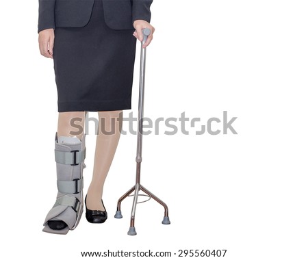 Business woman in suit with an ankle brace and stave