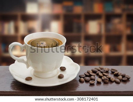 Coffee cup with smoke in front of bookshelf