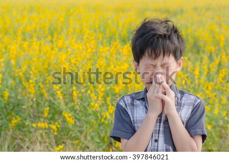 Little Asian boy has allergies from flower pollen