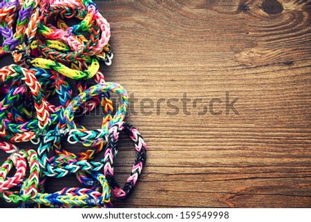 Rubber Band Loom Bracelets On A Wooden Table Background, Vintage Processed