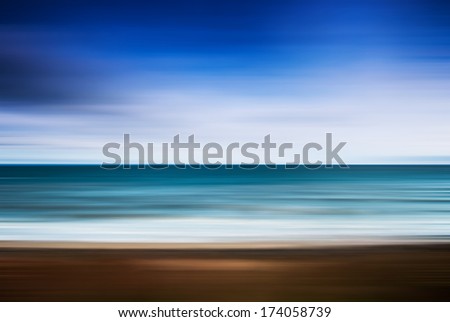 Sunrise at the beach. Blurred panning motion. Abstract seascape