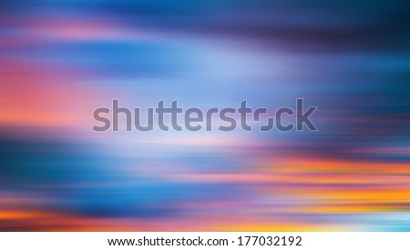 Sunset on a wild beach in Guanacaste, Costa Rica. Dramatic red and blue sunset sky. Clouds motion blur. Abstract romantic travel vacation concept