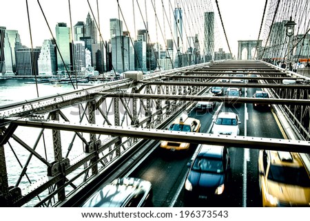 Speeding cars on Brooklyn Bridge. Urban living and transportation concept