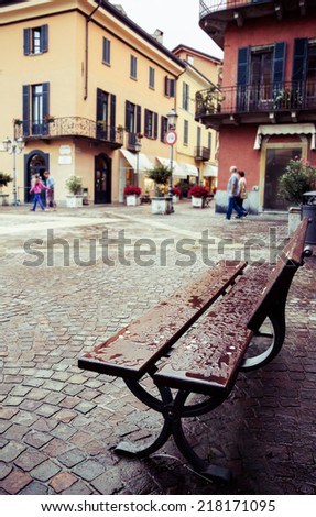 After the rain. Wet bench in Menaggio, Lake Como, Italy. Vintage, old city, European, travel and vacation concept.