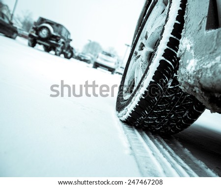 Winter driving conditions. Snow storm, snow tires,driving hazards and weather concept.
