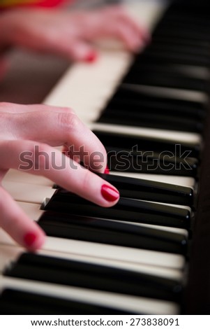 Young woman playing the piano. Music and education concept