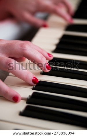 Young woman playing the piano. Music and education concept
