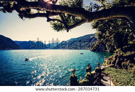 Lake Como. People on a boat ride on the lake. Summer time. European vacation, living life style, architecture and travel concept.. Vintage post processed