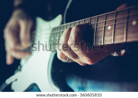 Young man playing electric guitar. Music, instrument education, entertainment, rock star, music concert   and learning concept