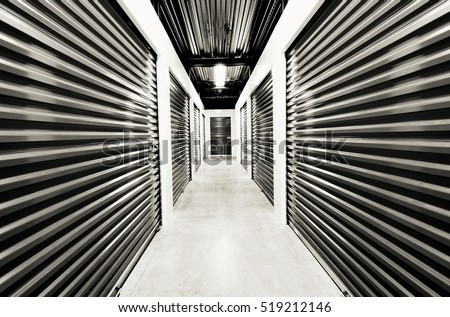 Self storage doors. Life style, storage, moving, storing, organizing concept. Grungy background, black and white post processed