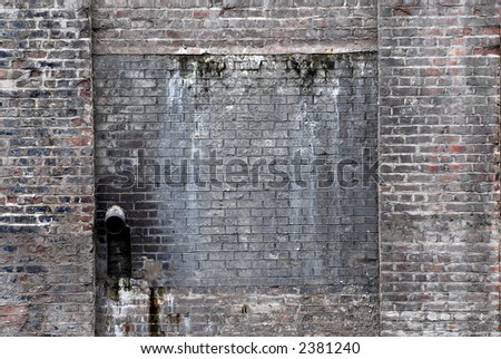 Brick wall with waste pipe. Ideal background.
