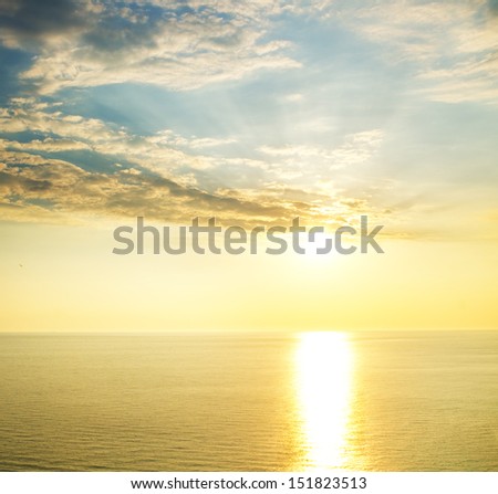 Sun glow and reflection at sunset. Bright seascape