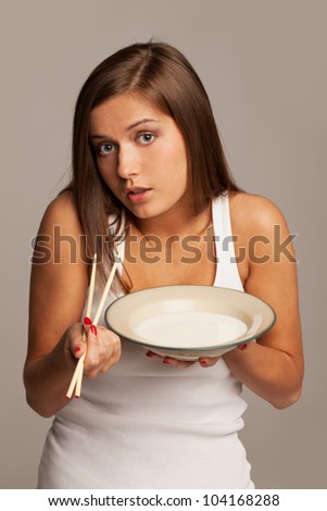 Girl is asking if it is possible to eat milk with chopsticks